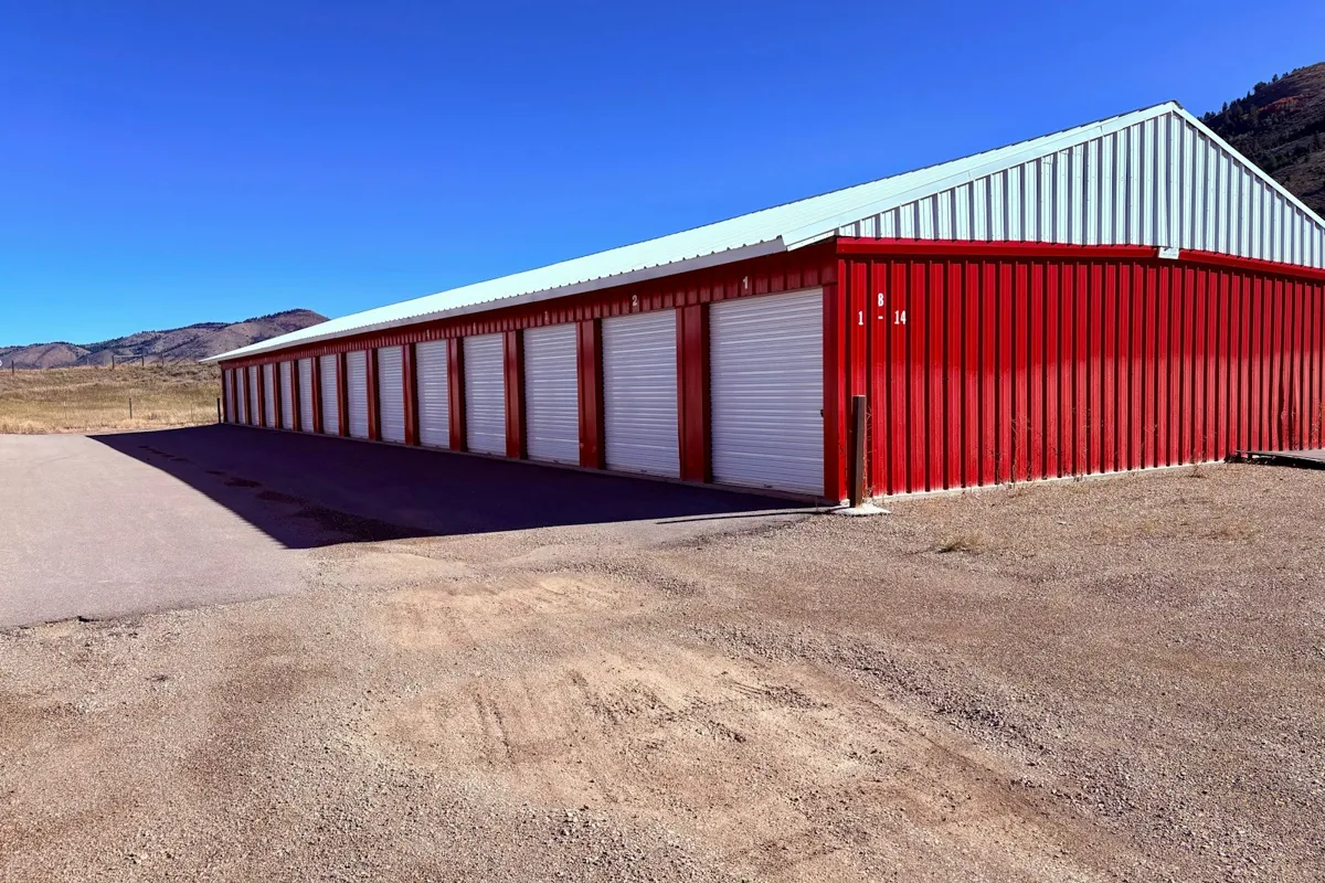 Red self-storage building with a long row of roll-up doors